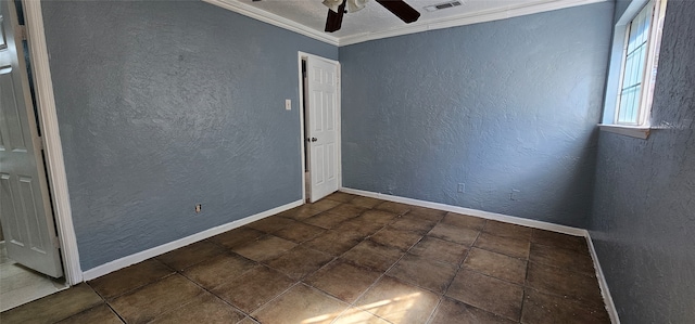 tiled empty room featuring ceiling fan and crown molding