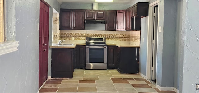 kitchen with stainless steel stove, sink, and backsplash