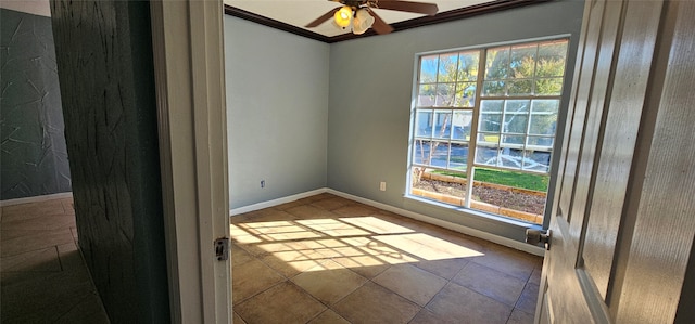 tiled empty room with a wealth of natural light, ceiling fan, and ornamental molding