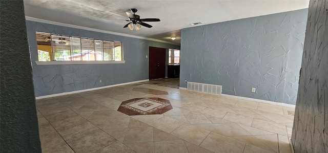 spare room featuring ornamental molding, tile patterned floors, and ceiling fan