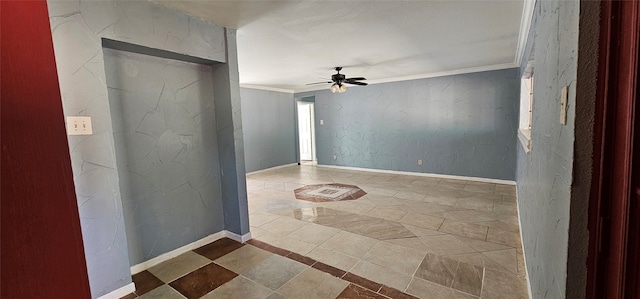 spare room featuring ceiling fan and ornamental molding