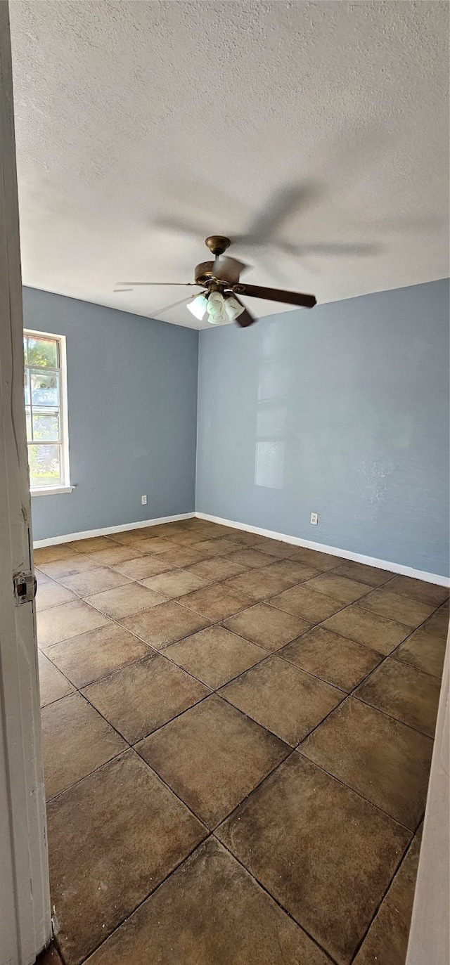 spare room with a textured ceiling and ceiling fan