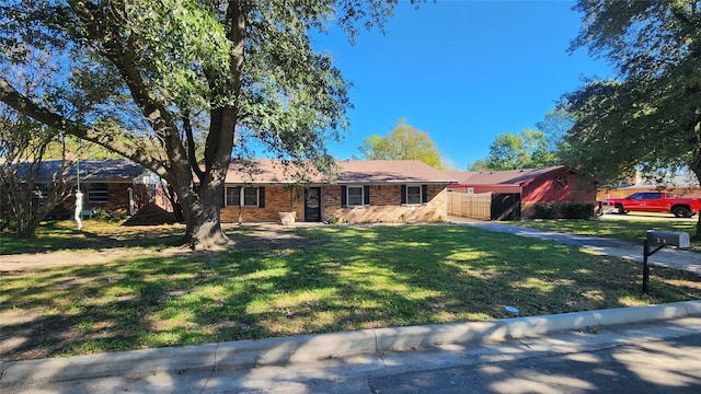 ranch-style home with a front lawn