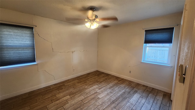 empty room with ceiling fan and wood-type flooring