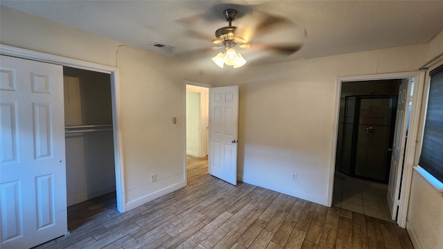 unfurnished bedroom featuring a closet, ceiling fan, and light wood-type flooring