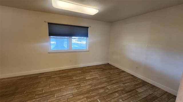 unfurnished room with dark wood-type flooring