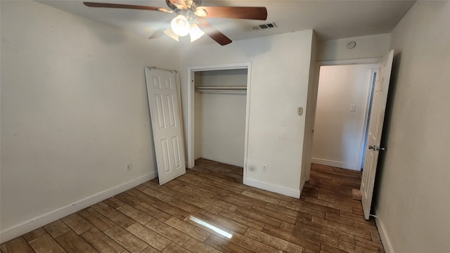 unfurnished bedroom featuring dark hardwood / wood-style flooring, a closet, and ceiling fan