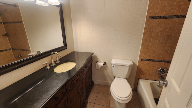 full bathroom featuring tile patterned flooring, vanity, toilet, and tiled shower / bath