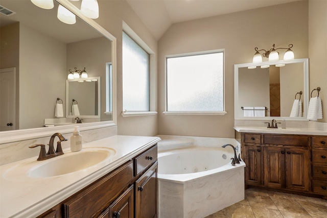 bathroom with a tub to relax in, vanity, tile patterned flooring, and lofted ceiling