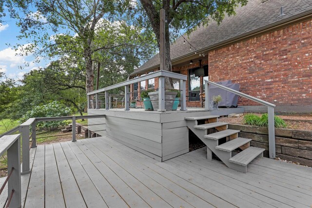 rear view of house with a sunroom and a deck