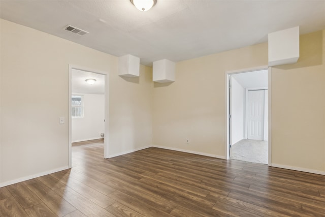 spare room with dark hardwood / wood-style floors