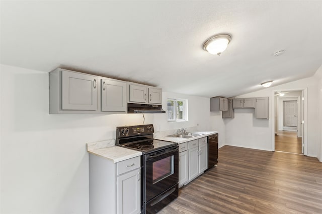 kitchen featuring black appliances, dark hardwood / wood-style floors, gray cabinets, sink, and vaulted ceiling