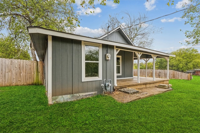 rear view of property featuring a yard