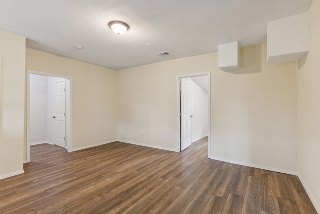 empty room with dark hardwood / wood-style floors