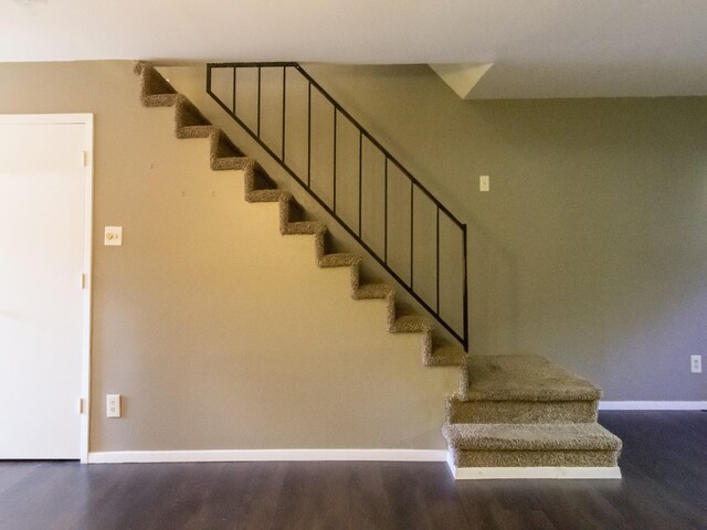 stairs featuring hardwood / wood-style floors