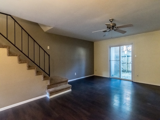 unfurnished living room featuring ceiling fan and dark hardwood / wood-style floors