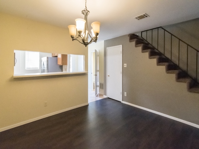 interior space featuring hardwood / wood-style floors and a notable chandelier