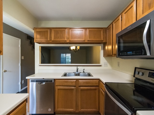 kitchen with a chandelier, sink, and appliances with stainless steel finishes