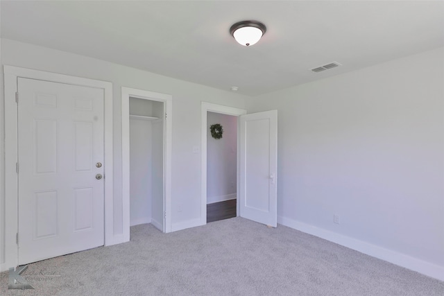 unfurnished bedroom featuring light colored carpet