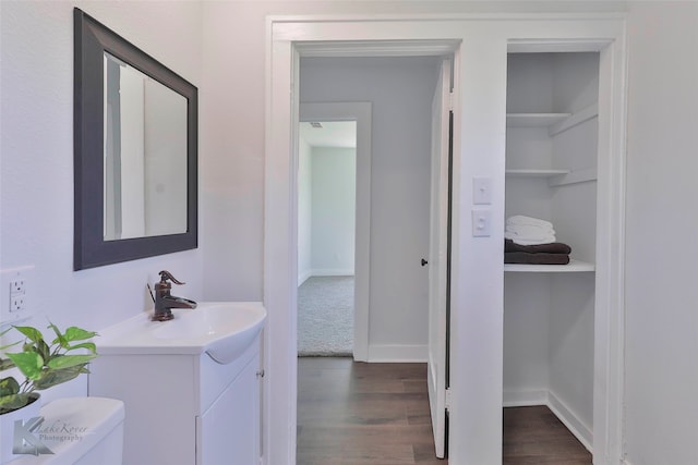 bathroom featuring hardwood / wood-style floors, vanity, and toilet