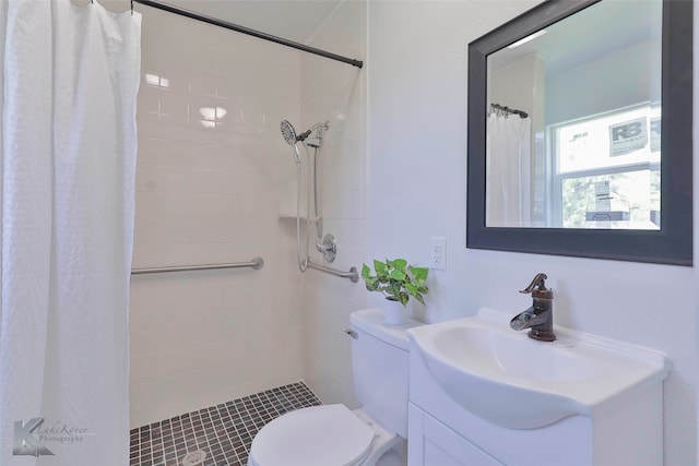 bathroom featuring walk in shower, vanity, and toilet