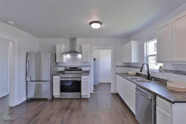 kitchen with stainless steel appliances, sink, wall chimney exhaust hood, dark hardwood / wood-style floors, and white cabinets