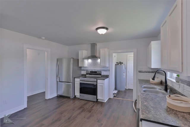 kitchen with white cabinetry, wall chimney range hood, sink, and stainless steel appliances