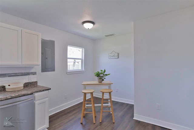 dining space with electric panel and dark hardwood / wood-style flooring