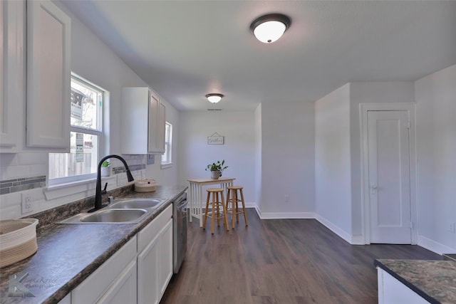 kitchen featuring white cabinets, dark hardwood / wood-style floors, sink, and tasteful backsplash