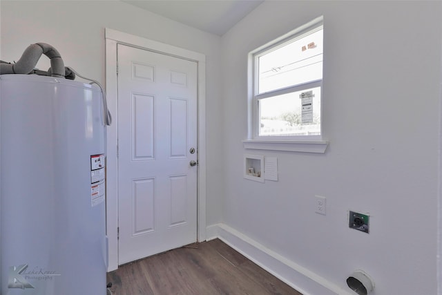 clothes washing area with water heater, hookup for a washing machine, hookup for an electric dryer, and dark hardwood / wood-style flooring