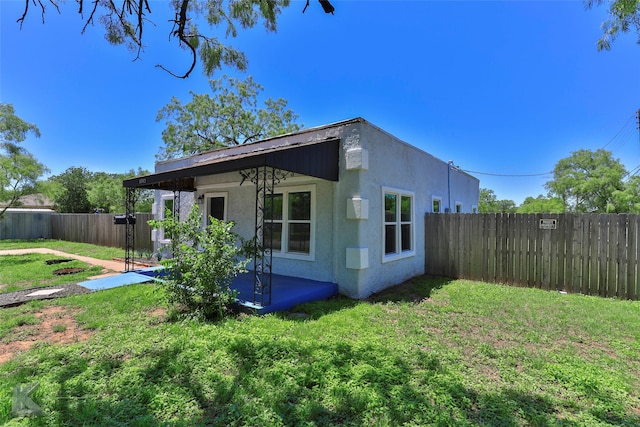 view of property exterior featuring a lawn