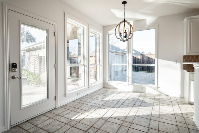 unfurnished dining area featuring a chandelier and a healthy amount of sunlight