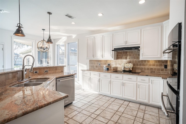 kitchen featuring pendant lighting, white cabinetry, sink, stainless steel dishwasher, and light stone counters