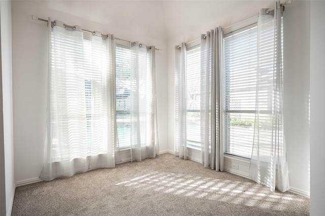 unfurnished room with light carpet and a wealth of natural light