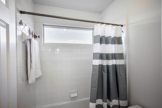 bathroom with shower / bath combo with shower curtain