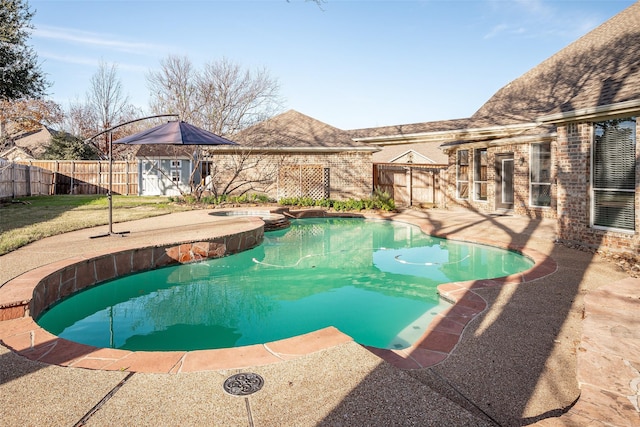 view of swimming pool featuring a storage shed and a patio area