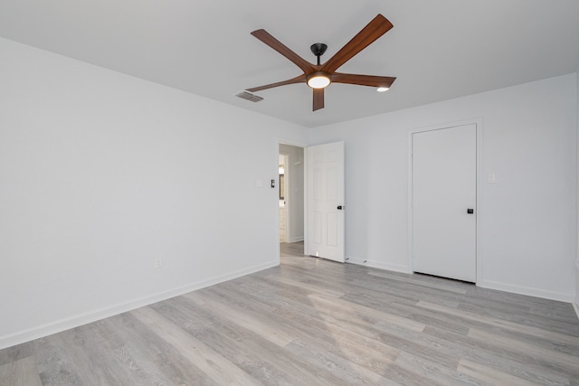 empty room with ceiling fan and light hardwood / wood-style floors