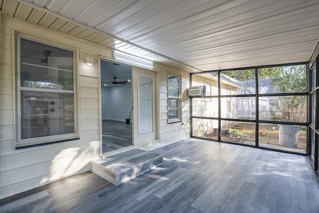 unfurnished sunroom with an AC wall unit, a wealth of natural light, wood ceiling, and ceiling fan