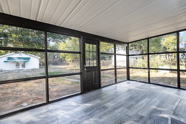 unfurnished sunroom with wooden ceiling