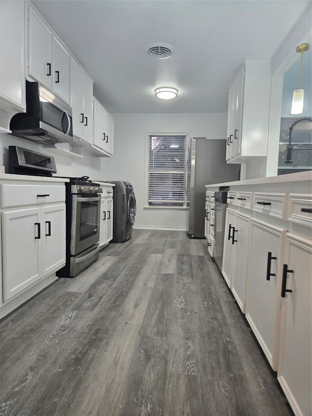 kitchen with white cabinetry, pendant lighting, and stainless steel appliances