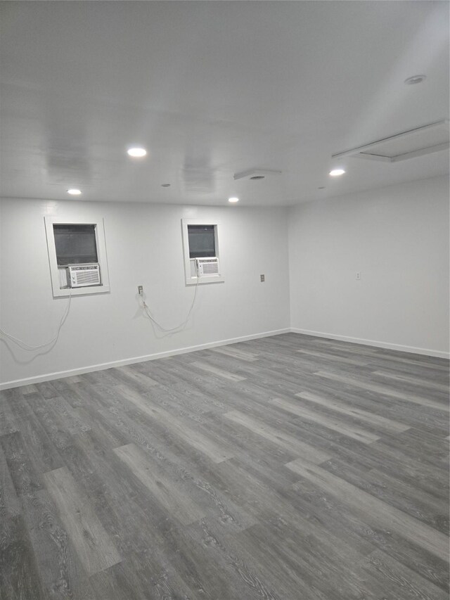 basement with hardwood / wood-style floors and cooling unit