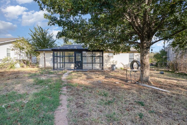 rear view of property featuring an outbuilding