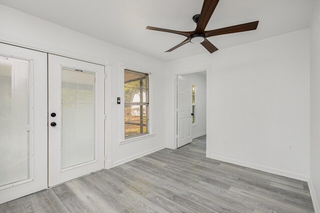 spare room with french doors, light hardwood / wood-style flooring, and ceiling fan