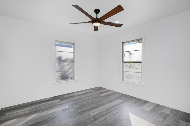 spare room with dark wood-type flooring and ceiling fan