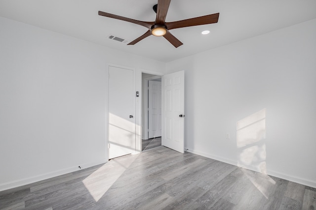 empty room featuring wood-type flooring and ceiling fan