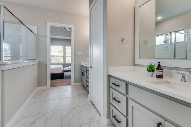 bathroom with ceiling fan, a shower with shower door, and vanity