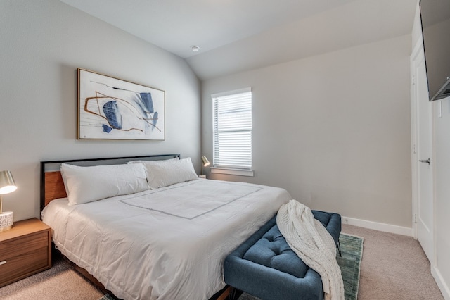 bedroom featuring vaulted ceiling and light colored carpet