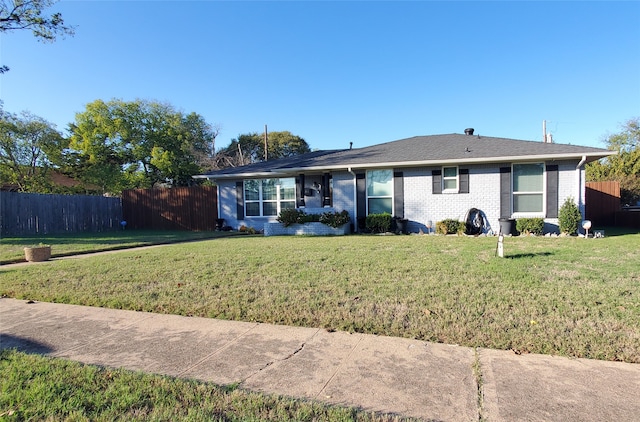 ranch-style home featuring a front yard