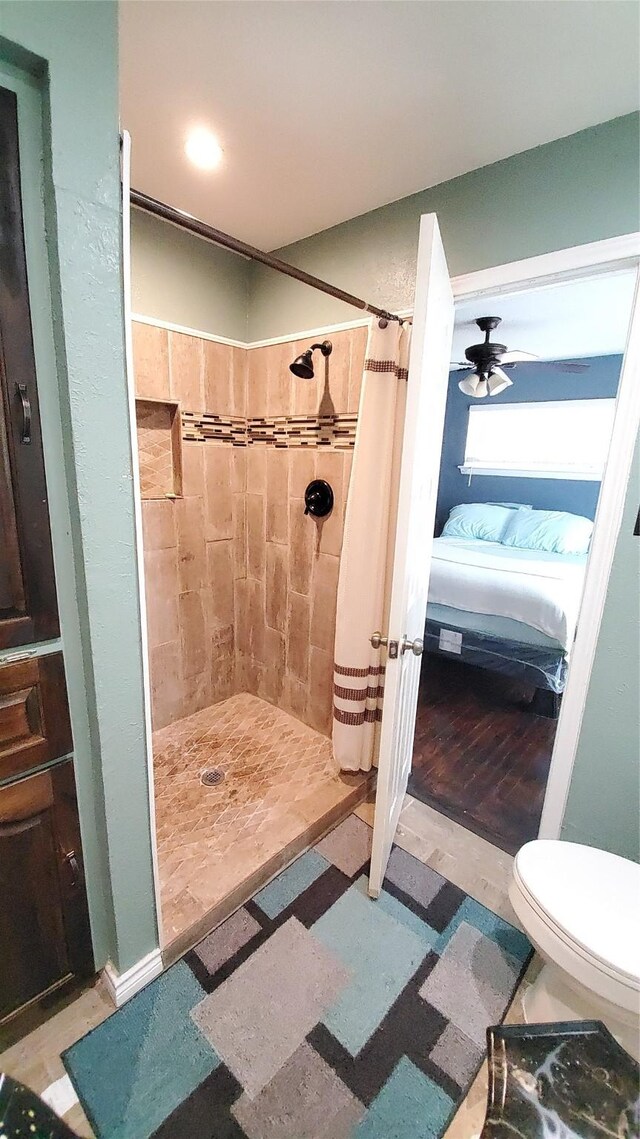 bathroom with a shower with curtain, ceiling fan, toilet, and wood-type flooring