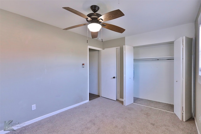 unfurnished bedroom featuring ceiling fan, a closet, and light colored carpet